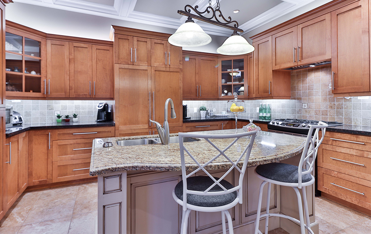 Wooden kitchen with a lilac island and seating by DeCasa Collections 