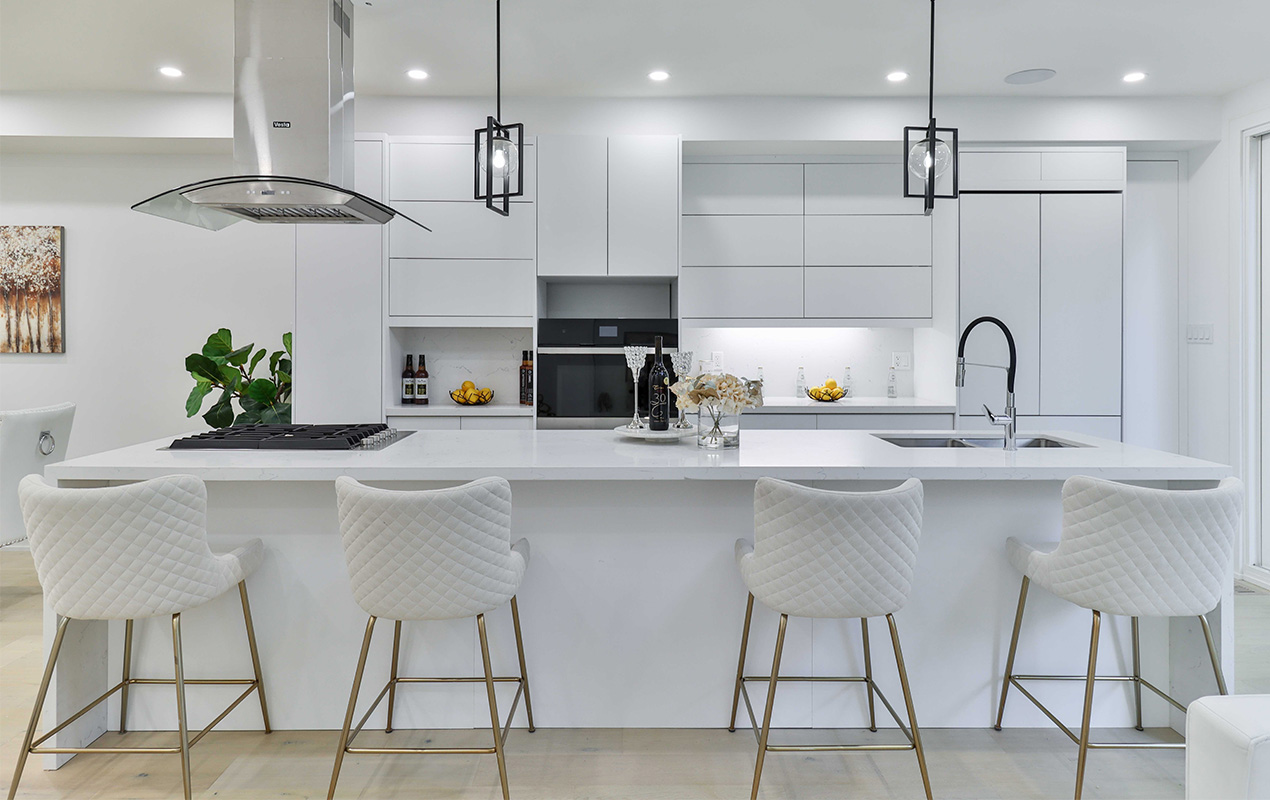 White kitchen with integrated sink and stove by DeCasa Collections