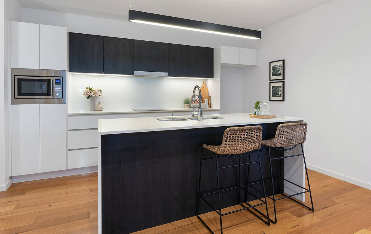 Large kitchen island with rattan seating by DeCasa Collections