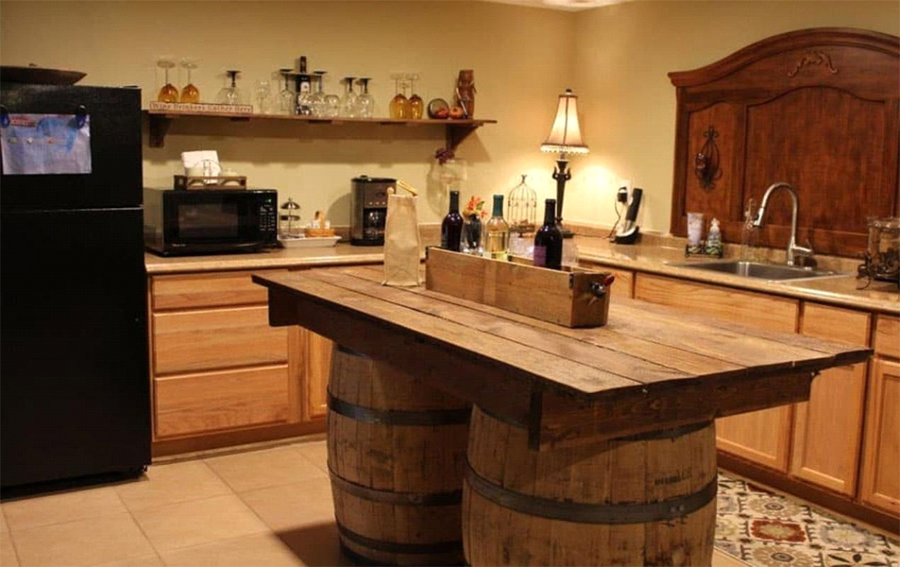 Kitchen island with wine barrel features by DeCasa Collections