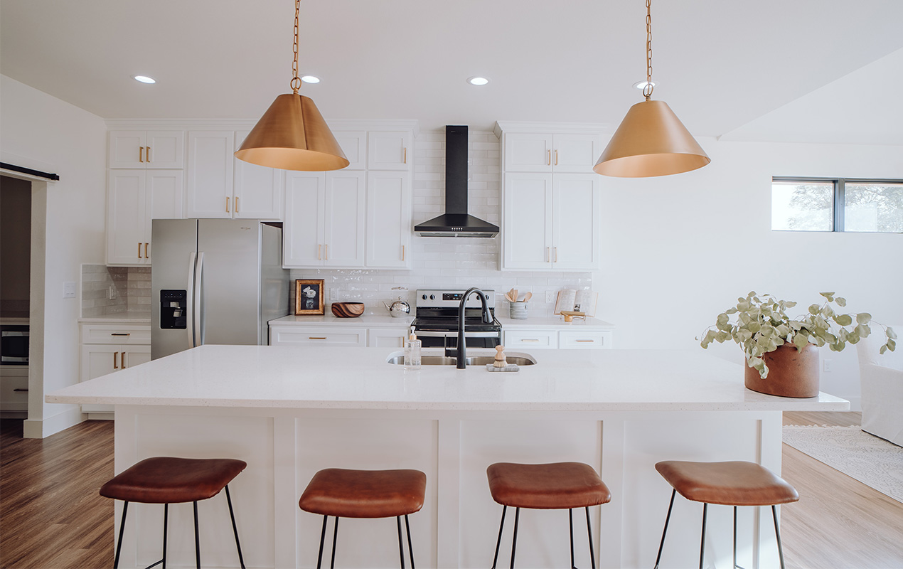 large kitchen island Interior with wooden stools by DeCasa Collections