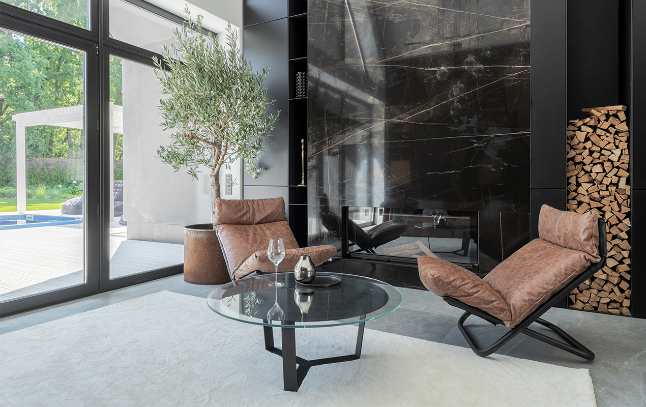 Living room interior tan leather seating glass coffee table.