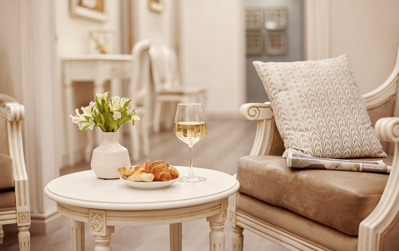 White marble coffee table with vase and croissants