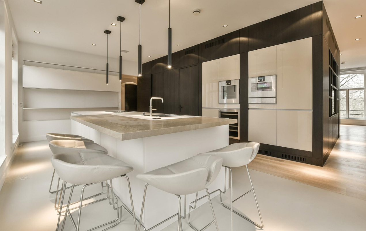 Kitchen with large island and chairs by DeCasa Collections