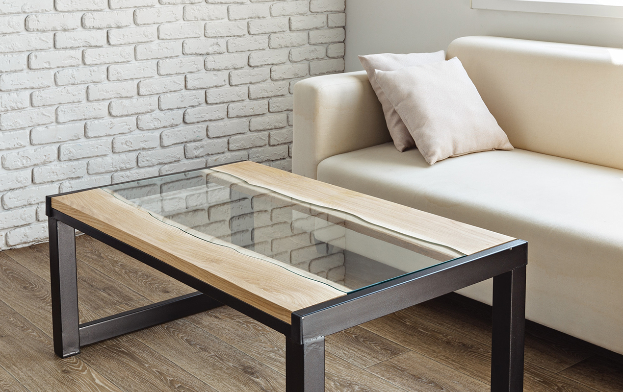 Wood and glass table white brick wall