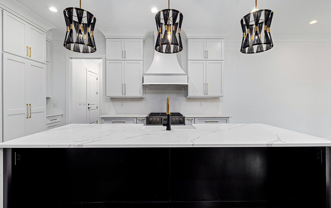Black kitchen island with white marble worktop by DeCasa Collections
