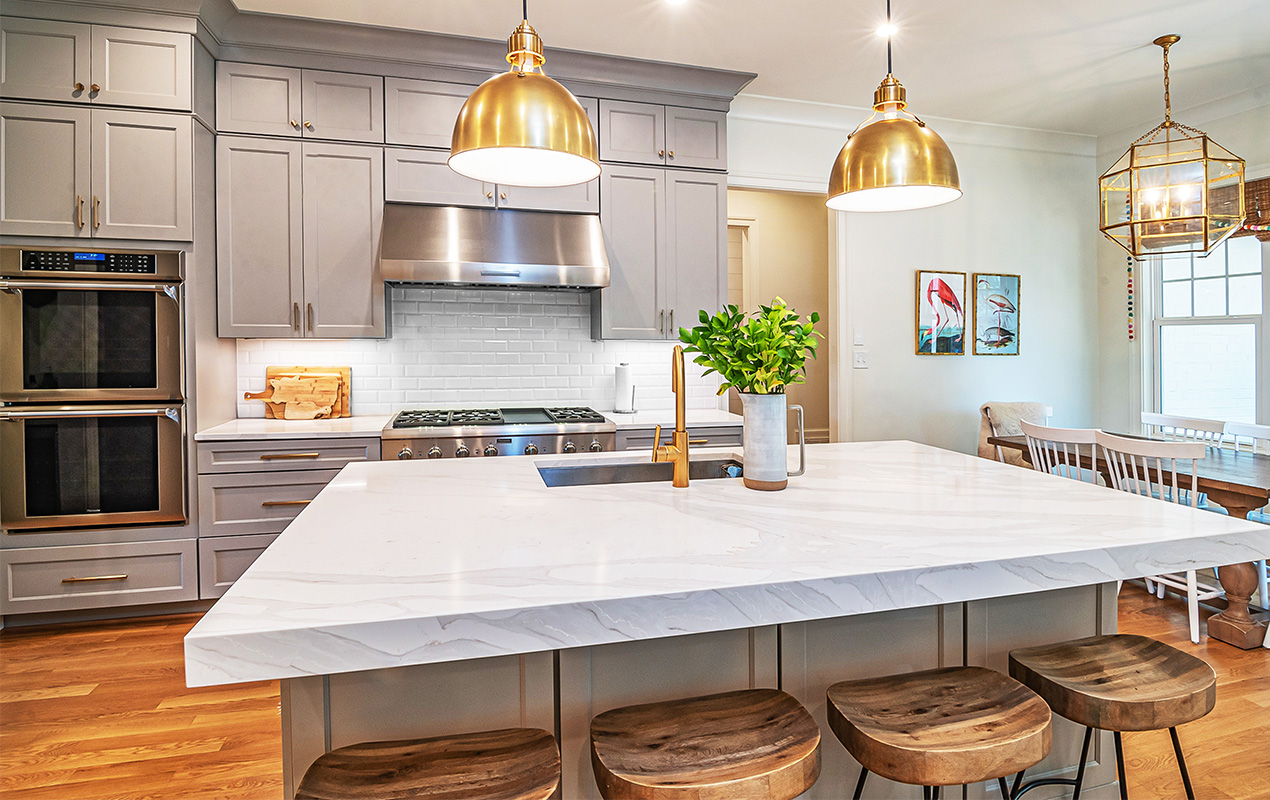 Kitchen design with gold pendant lights by DeCasa Collections