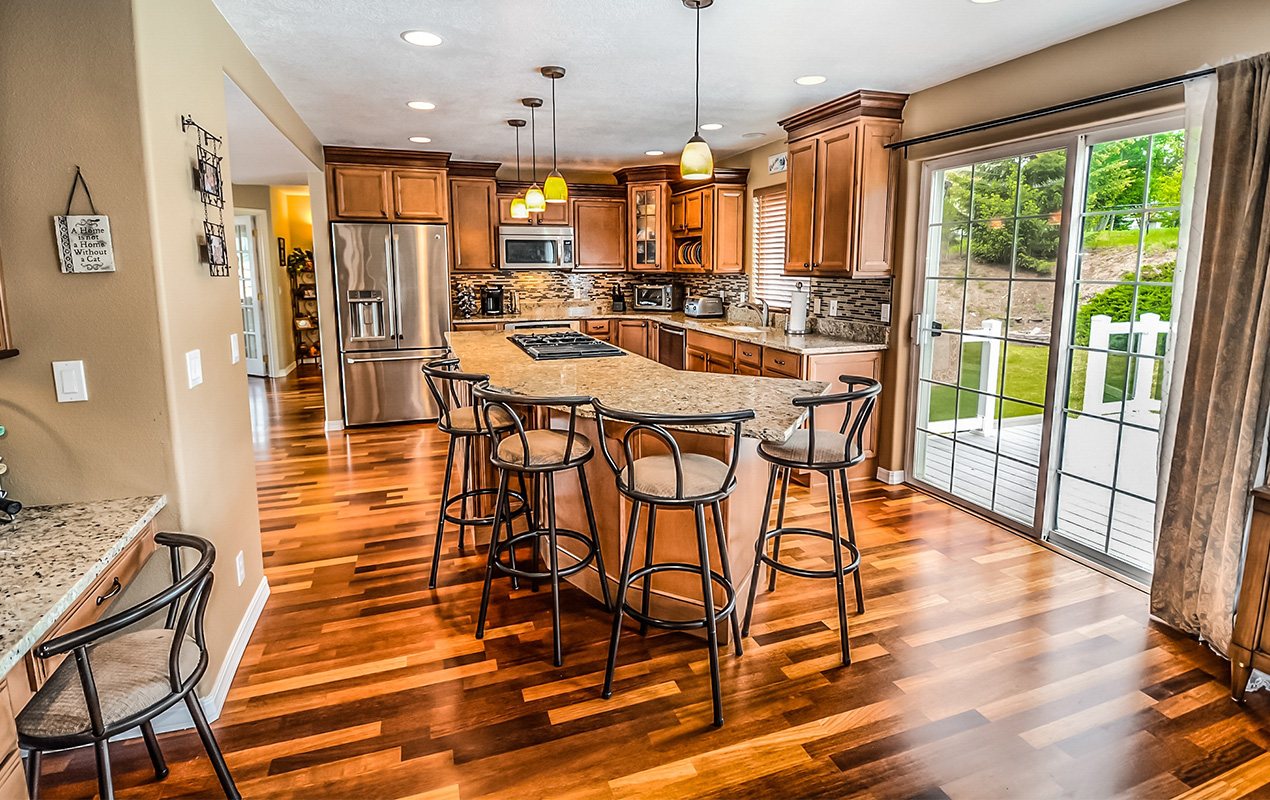 Rustic kitchen with island by DeCasa Collections