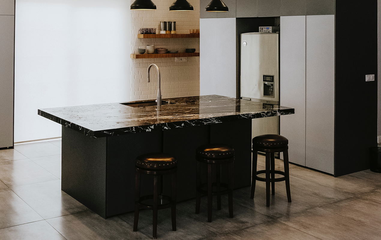 Black marble kitchen island by DeCasa Collections
