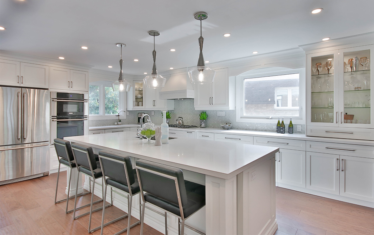 White kitchen island with black chairs by DeCasa Collections