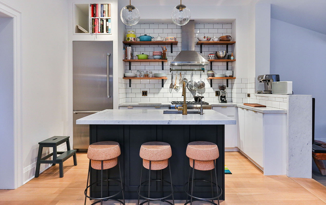 White interior with orange stools by DeCasa Collections