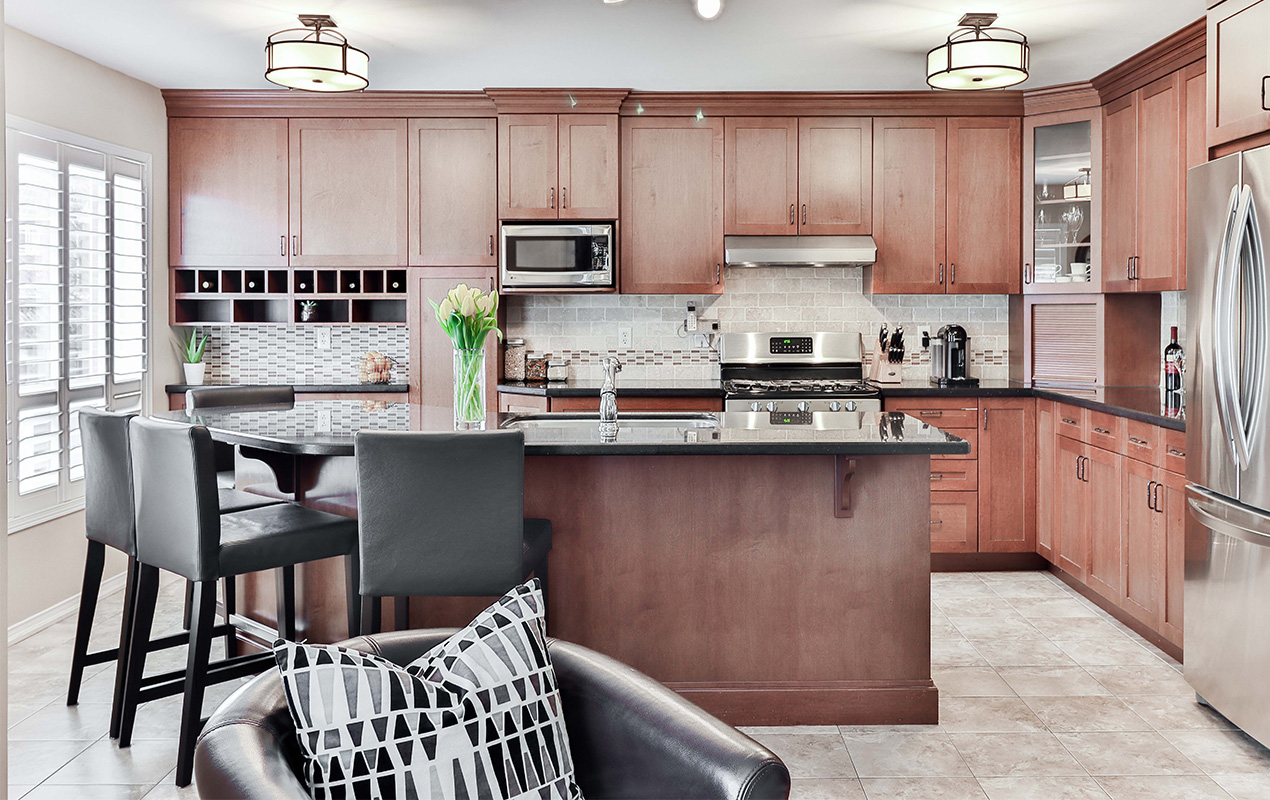 Wood kitchen with black chairs by DeCasa Collections