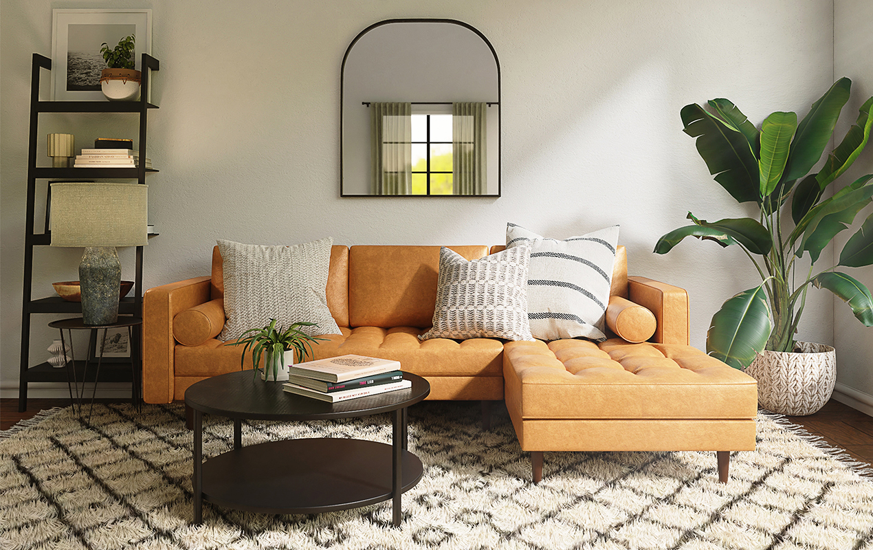 Living room interior with orange sofa and round coffee table.
