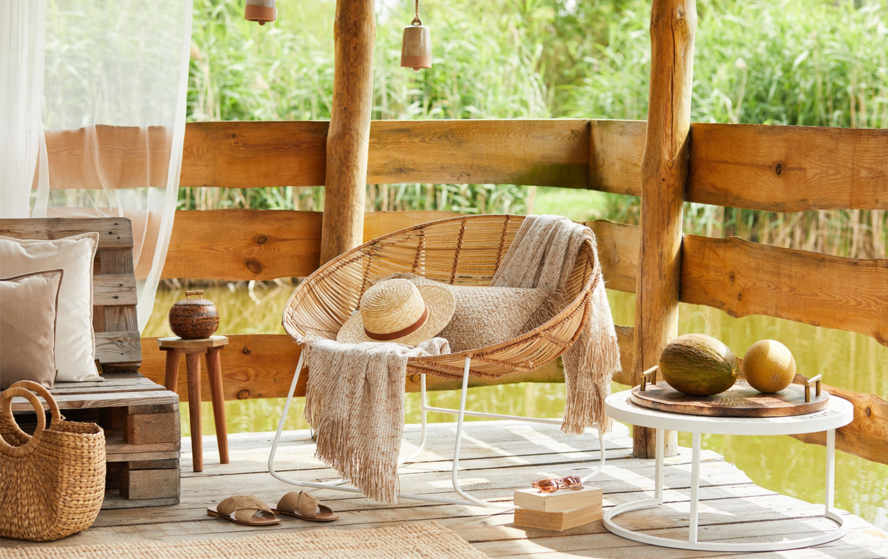 rattan armchair coffee table sofa pillows plaid elegant accessories modern decor