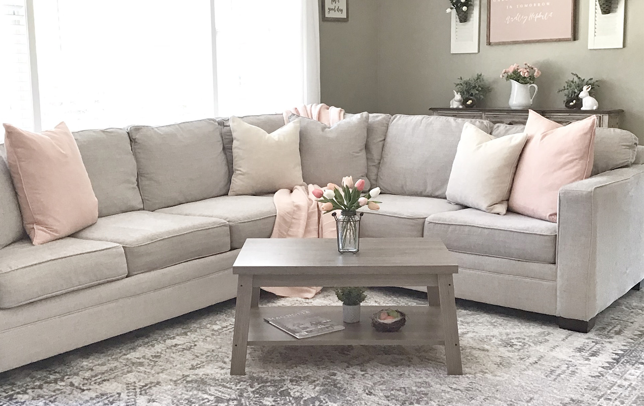 Gray and pink interior with sofa and coffee table.