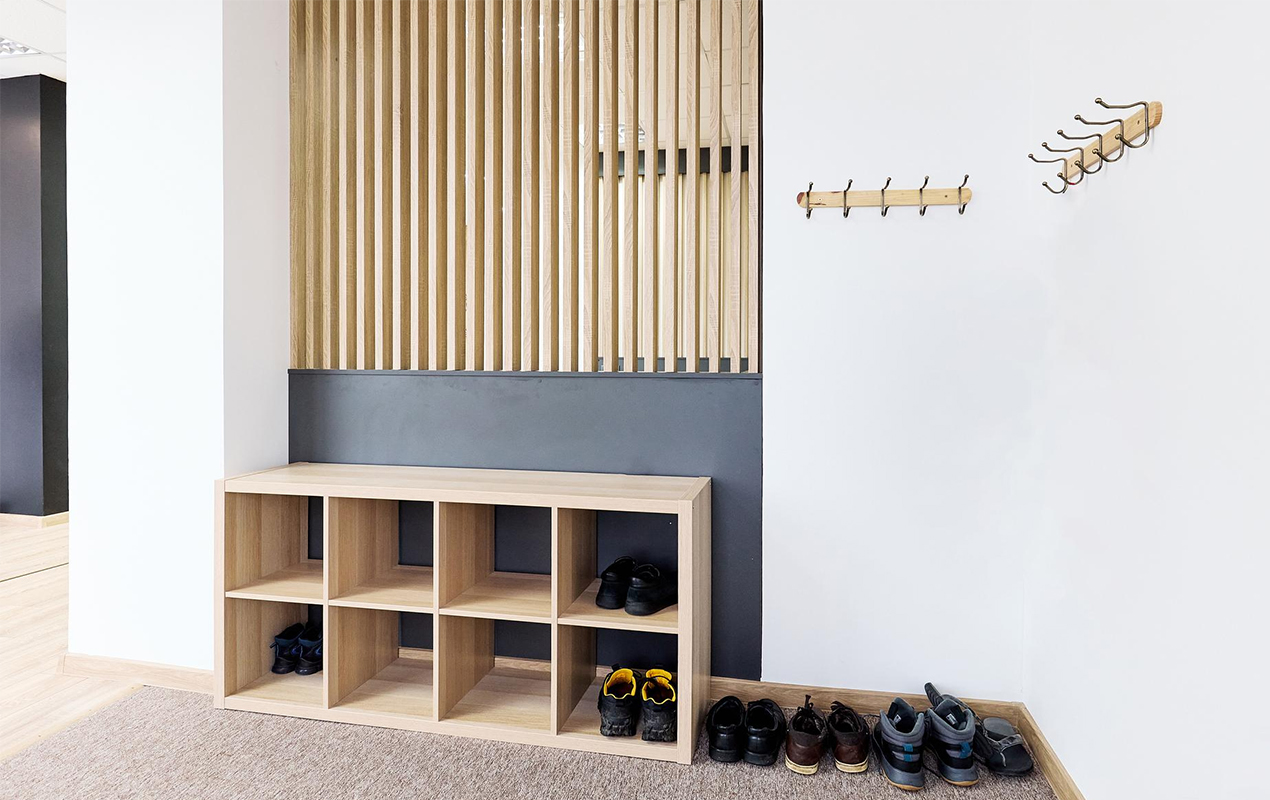 Wooden slat accent wall with shoe rack