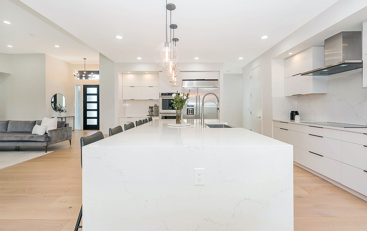 White marble kitchen island by DeCasa Collections