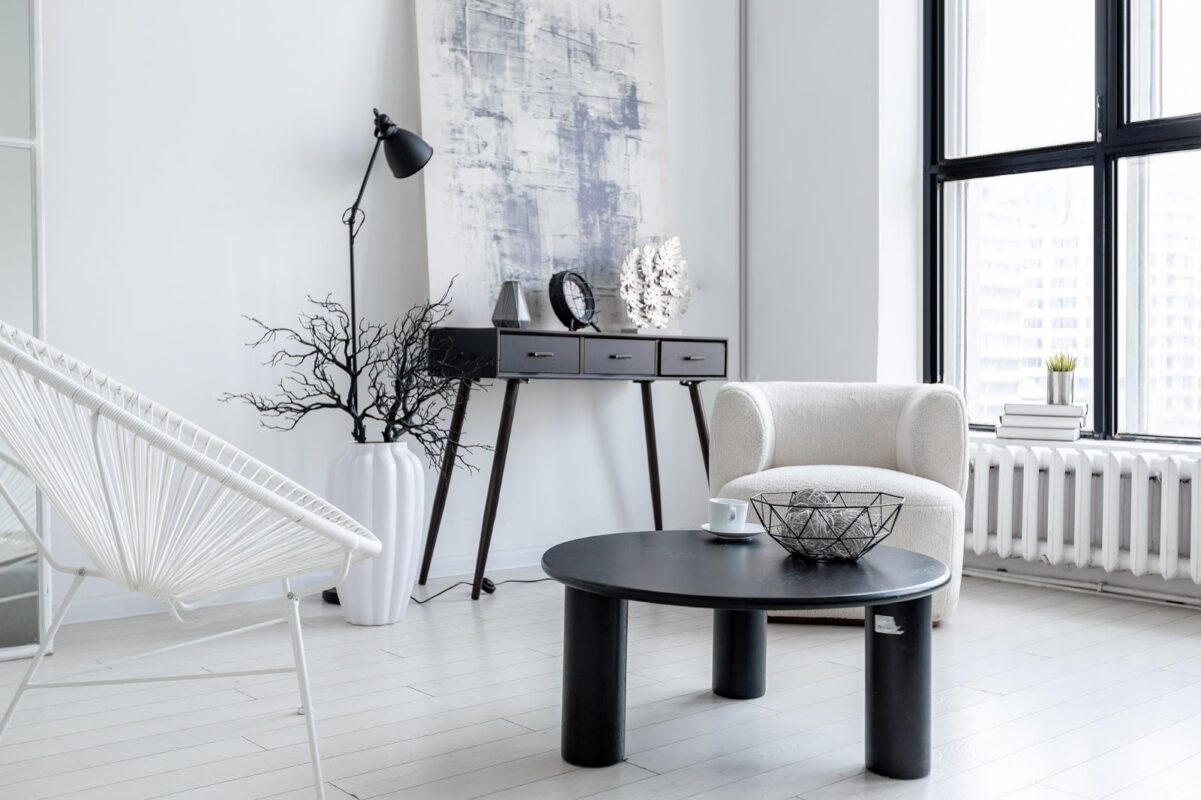 White living room with black coffee tables