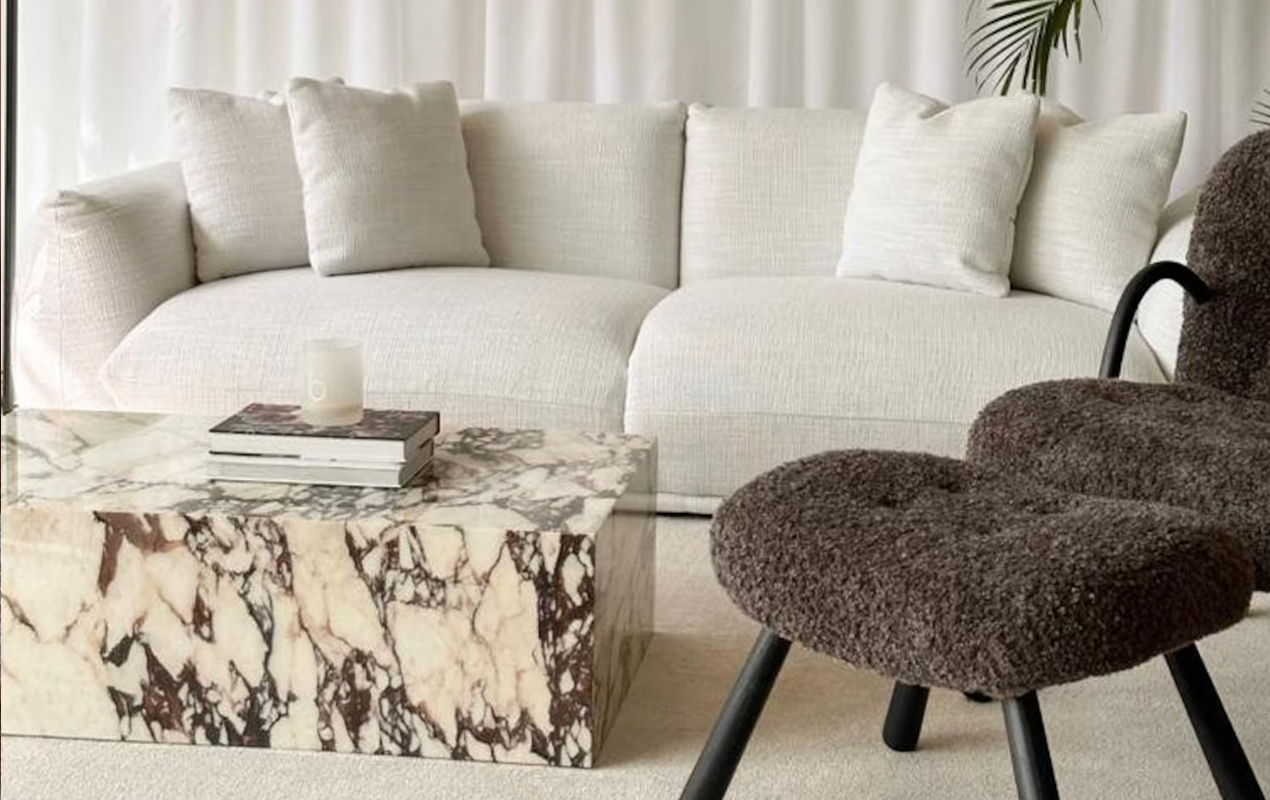 Living room with white sofa gray chair and veined table