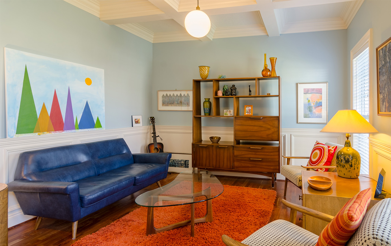 Colorful living room interior with blue wall and red carpet