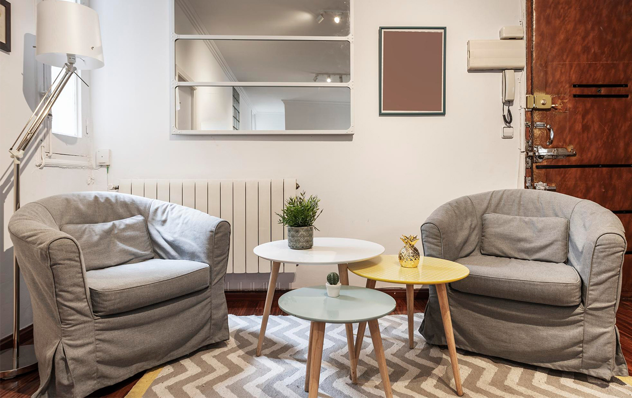 living room with several round side coffee tables