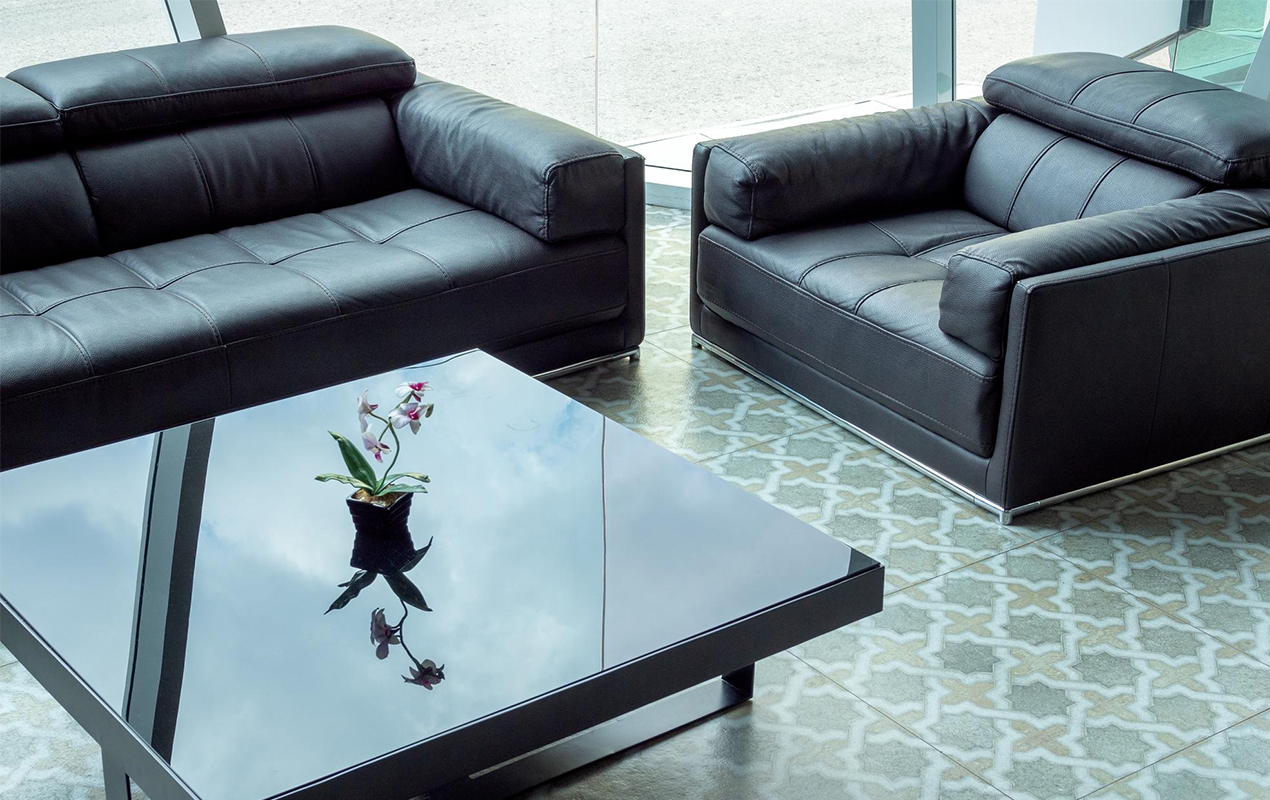 Modern black leather sofa and black glass table