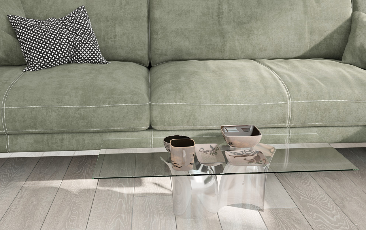 Clear coffee table with green sofa