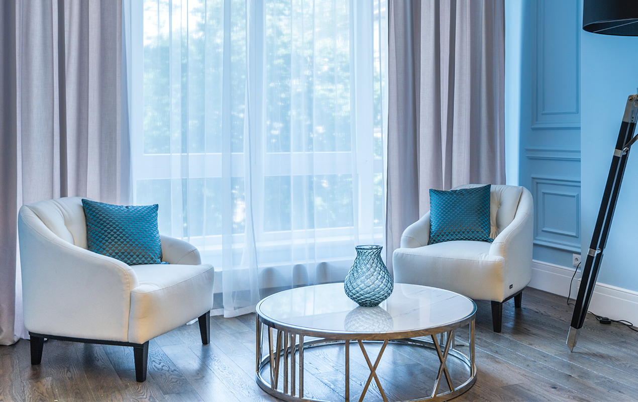 Modern living room with white furniture and blue wainscoting walls