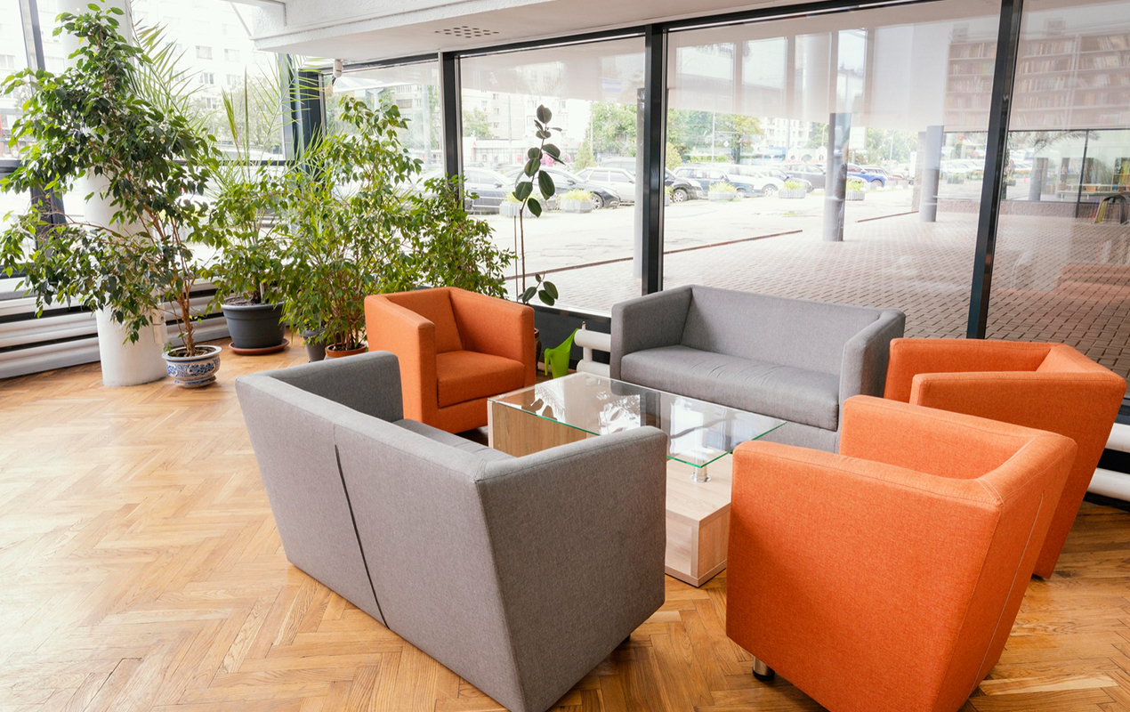 Seating area with gray and orange sofaa