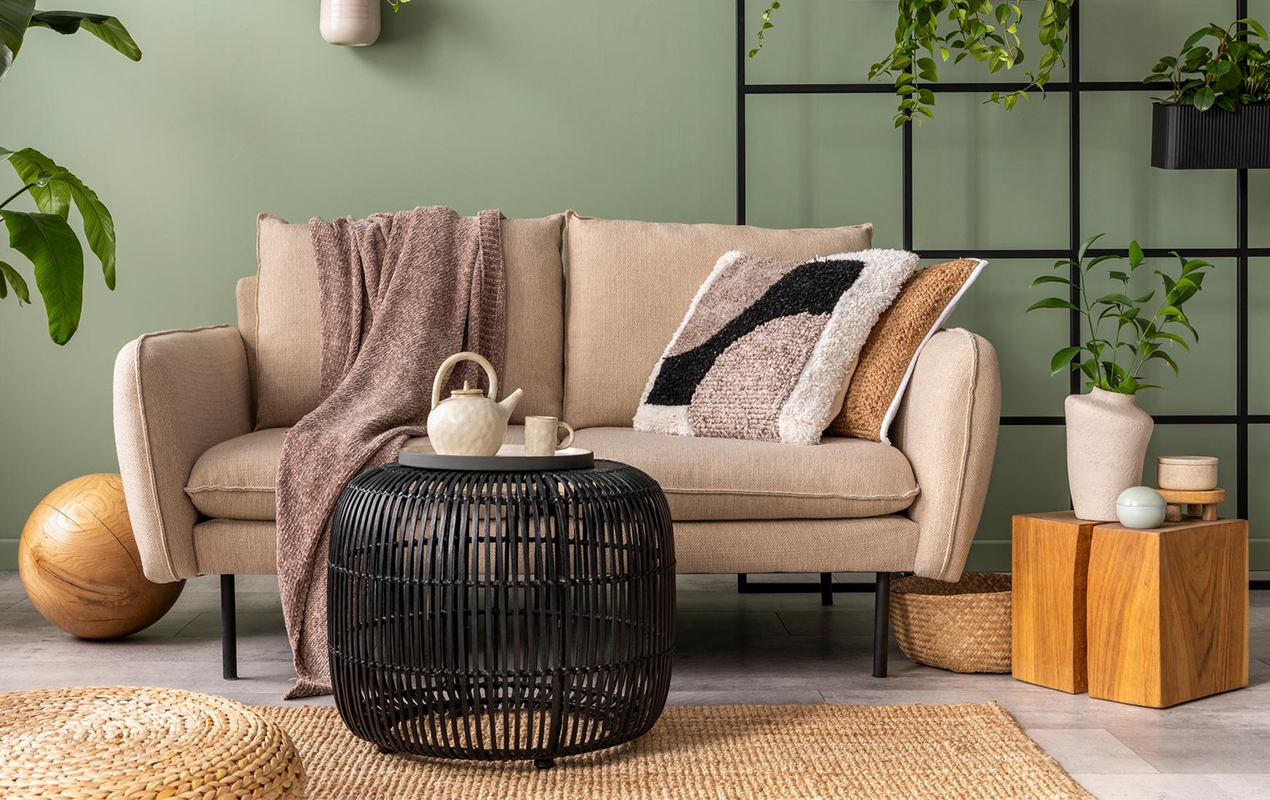 Interior with design beige sofa and black coffee table plants