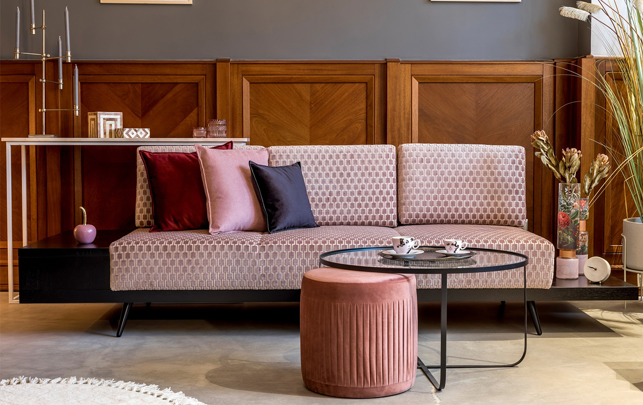 Living room with design pink velvet sofa elegant pouf coffee table