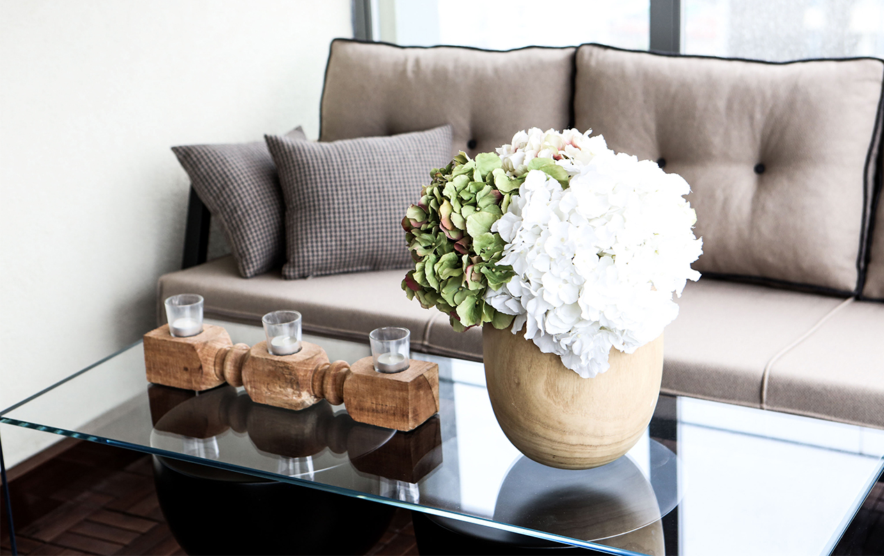 Neutral home interior with scented candles and white flowers