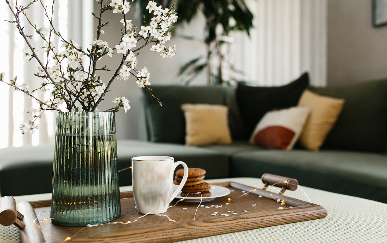 Green inspired living room with a serving tray and ribbed vase