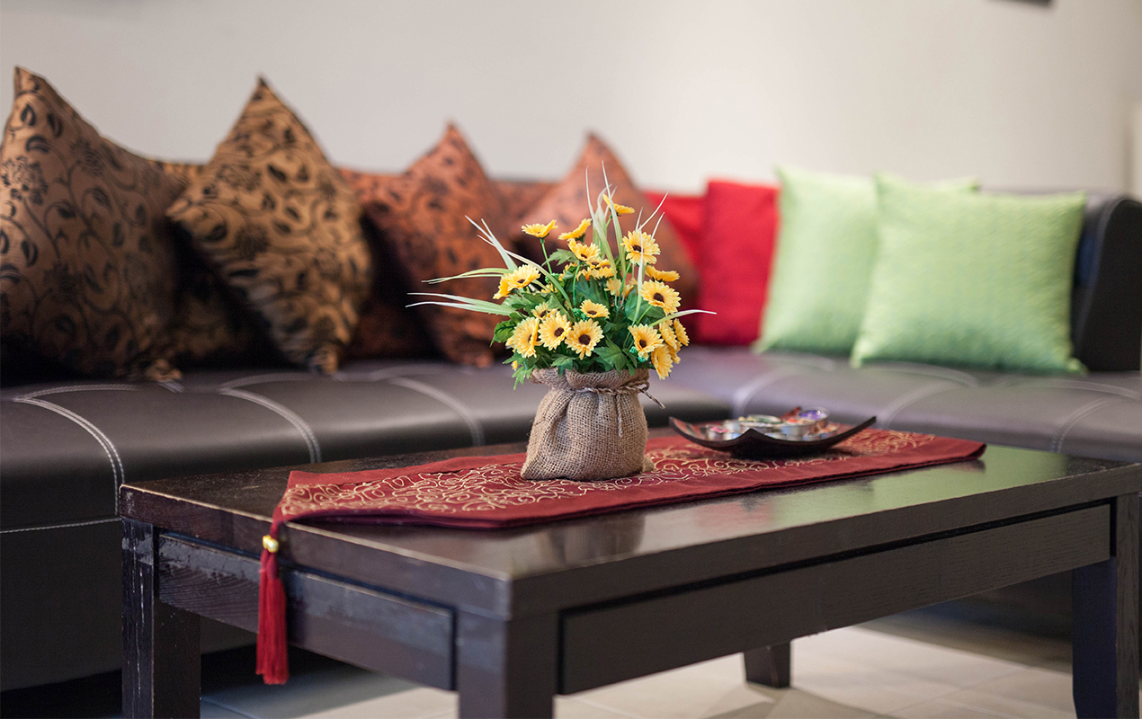 Living room with darkwood furniture and coffee table decor
