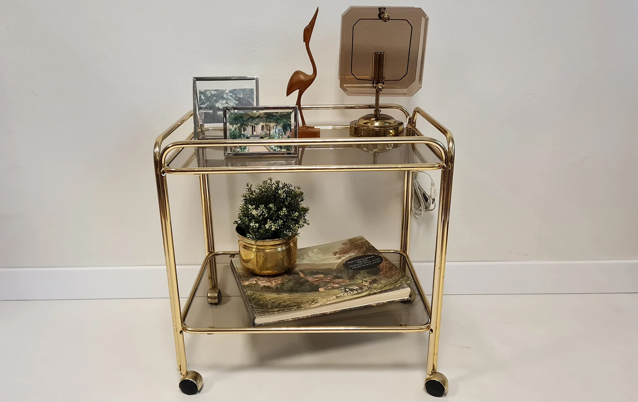 Rolling in Discernement: The Brass Trolley Coffee Table with Smoked Glass Top