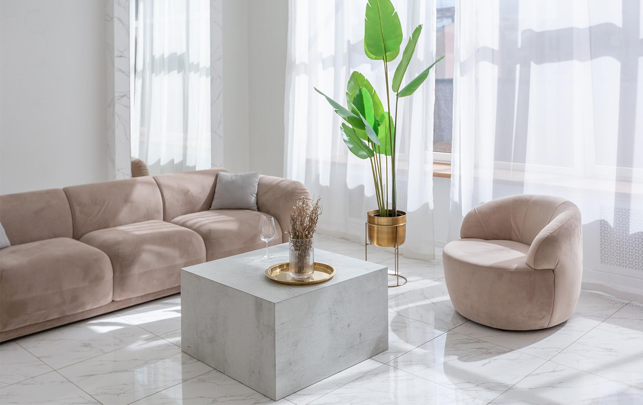 Lasting Flair: A Striking White Coffee Table and Marble Floor in a Sunlit Space