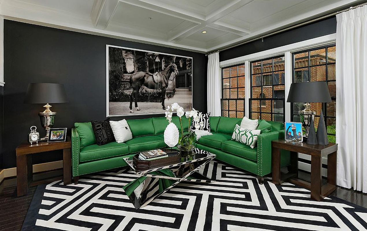 Living interior with greeen sofas, black and white flooring, and table
