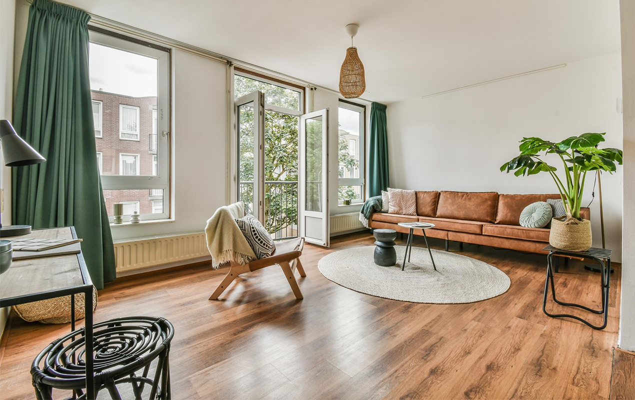 how to stage a round coffee table with white wall and wooden flooring. 