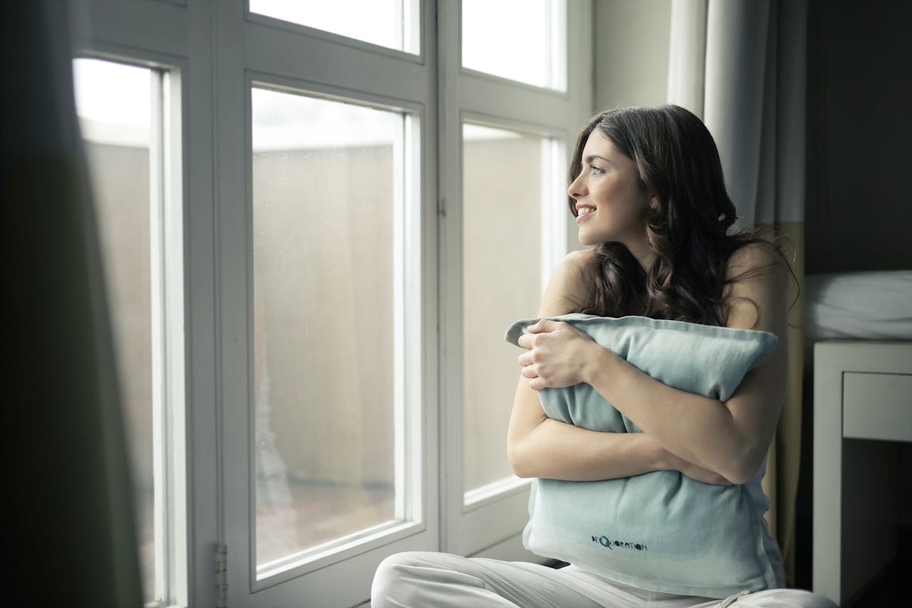 Woman sitting looking out of the window 