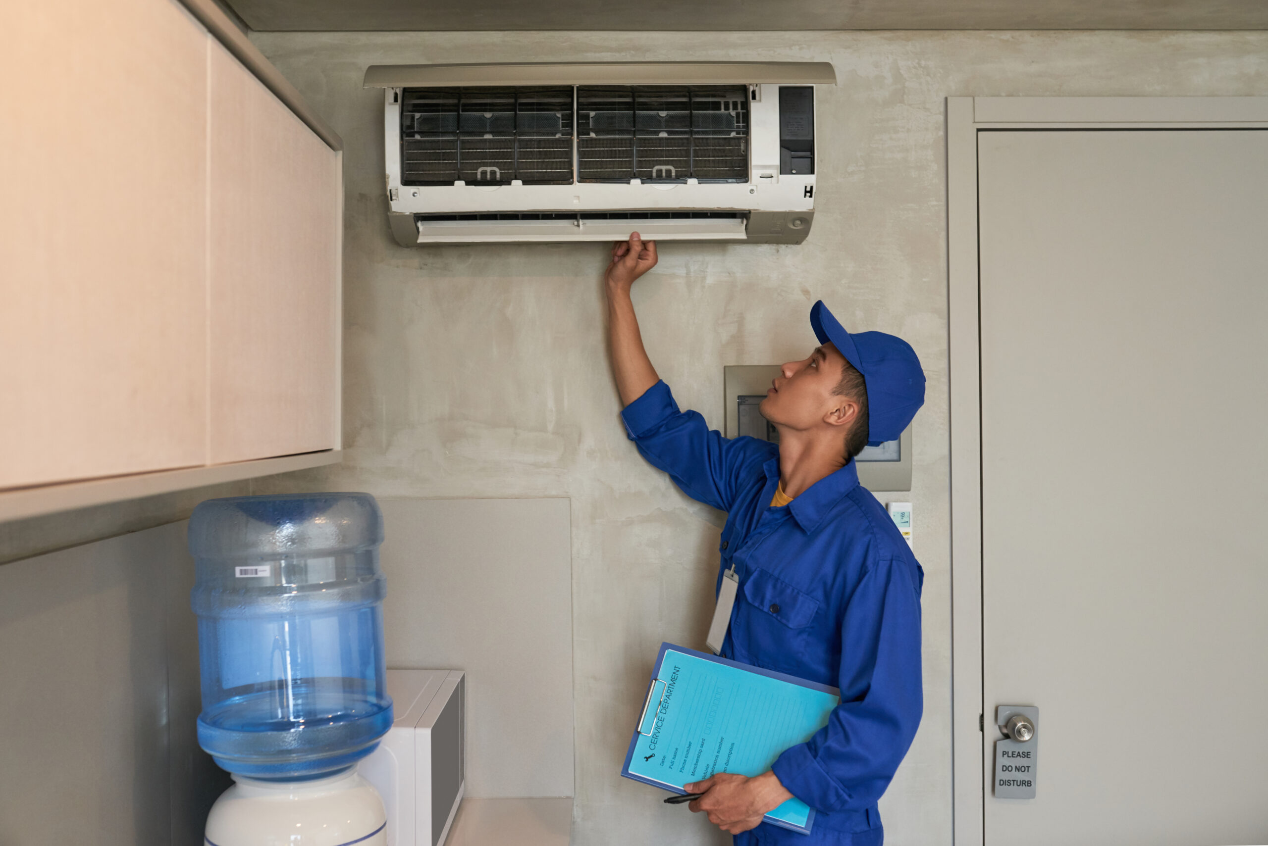 Young technician checking HVAC